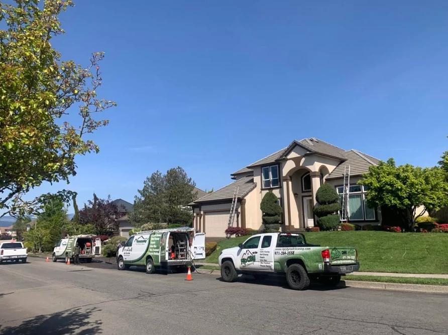 Rip City Roof Cleaning vehicles staged outside a residential work site