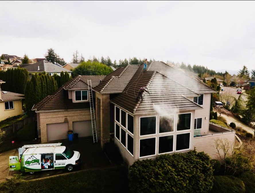 Rip City Roof Cleaning technicians working on a residential roof during exterior cleaning
